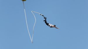 También conocido como bungee jumping es una actividad en la cuál una persona se lanza desde una gran altura con una cuerda elástica atada al torso o al tobillo.